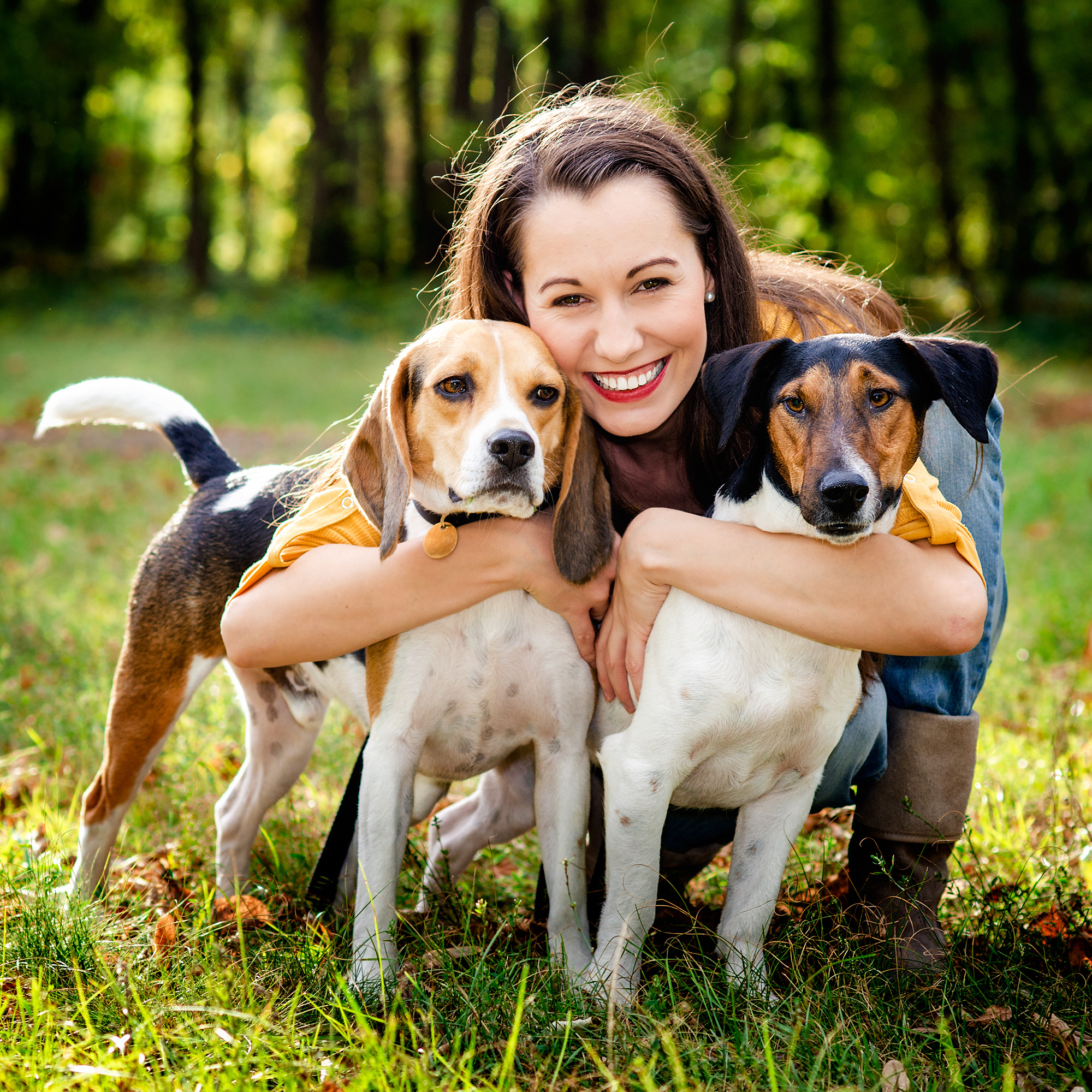 Woman Hugging Two Dogs